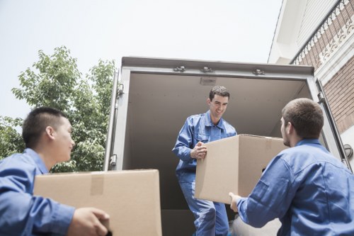 Professional movers handling office equipment